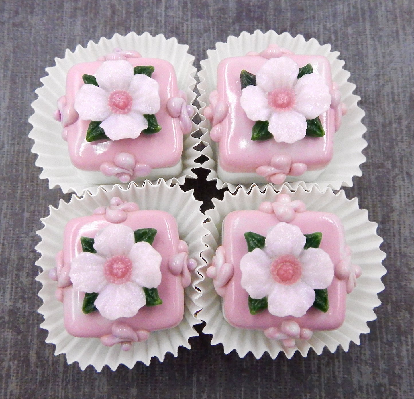 Pale Pink Primrose atop a Strawberry Petit Four Chocolate (81-102S)