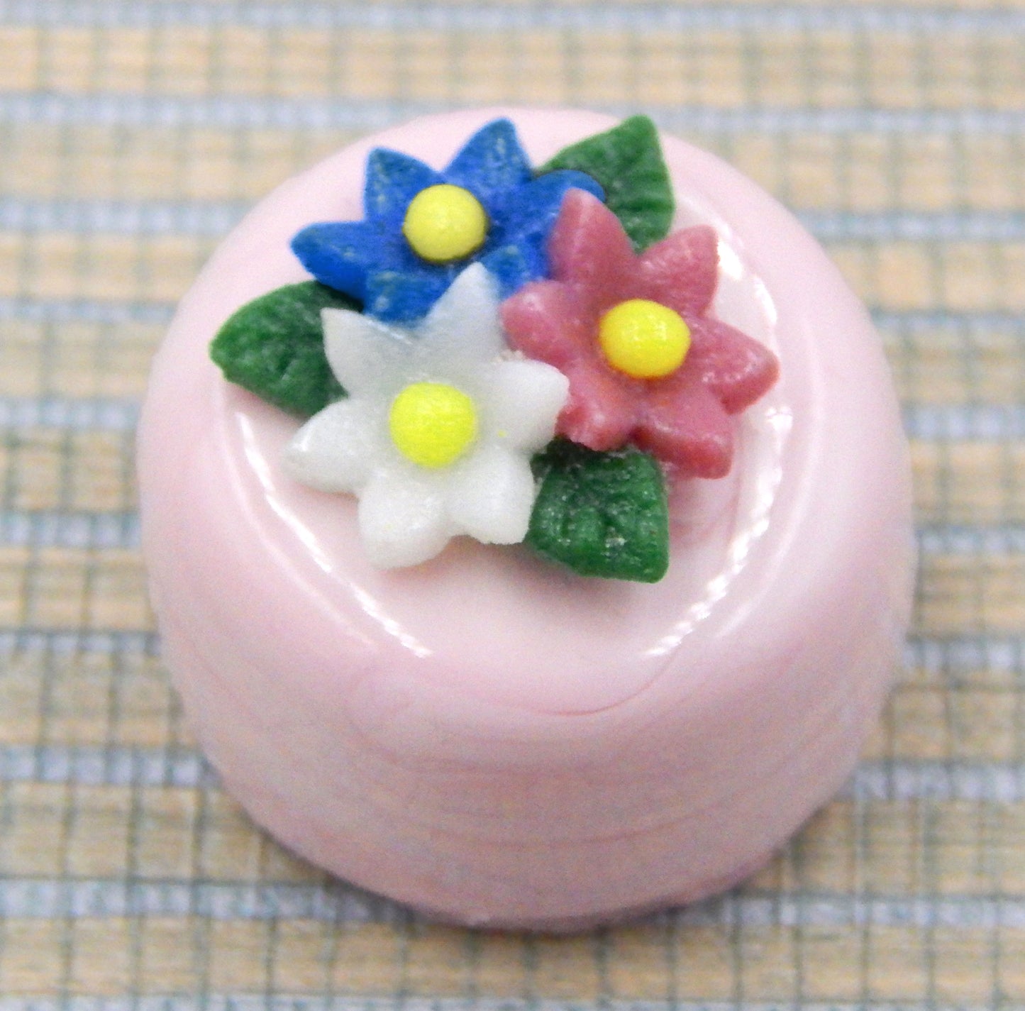 Three Flower Nosegay atop a Pink/White Petit Four Chocolate (81-123S)